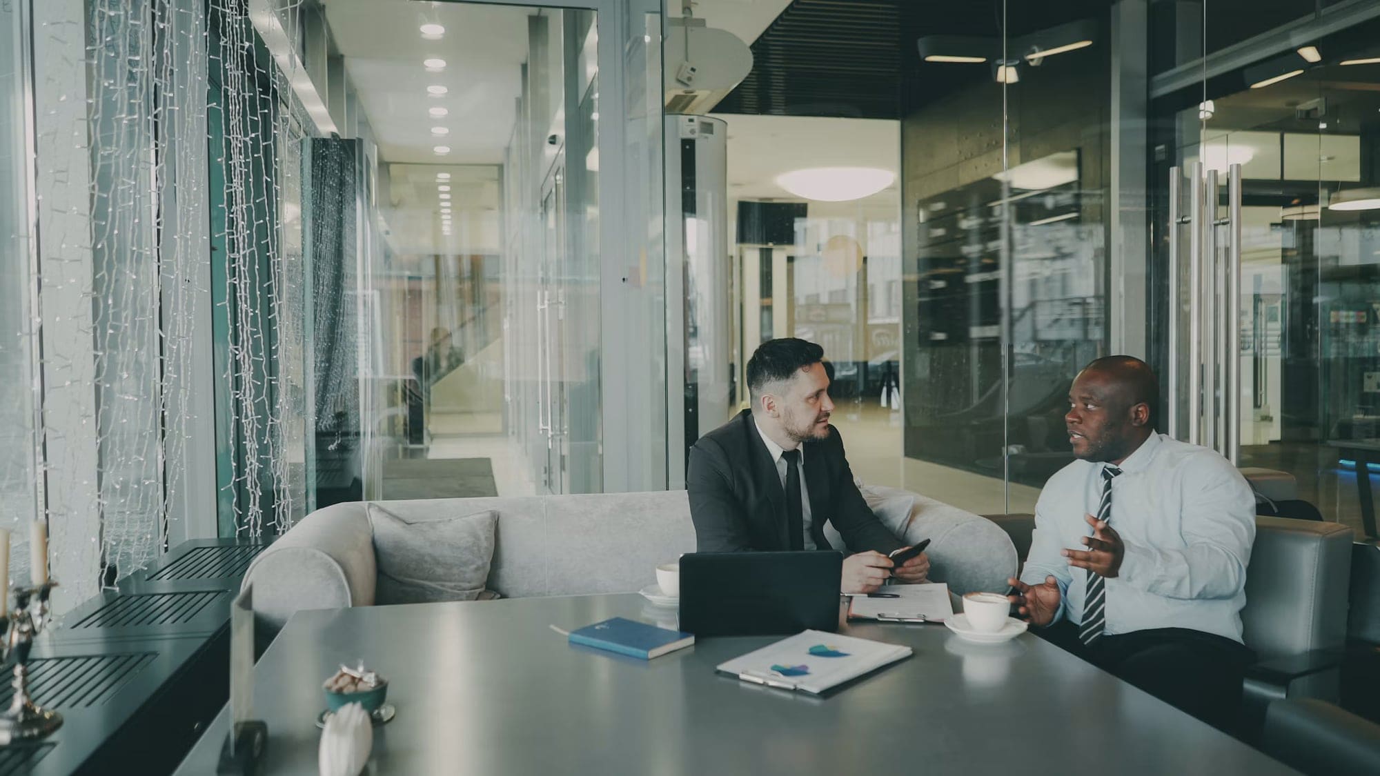 Two Wave Search consultants in a glass-walled meeting room